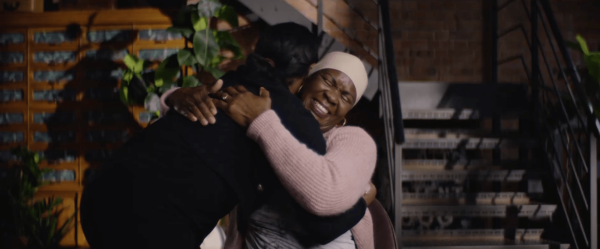 Two people hugging on a staircase