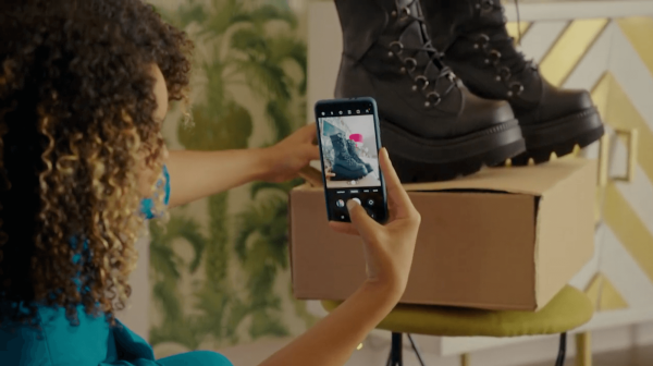 Close-up of a phone photographing boots