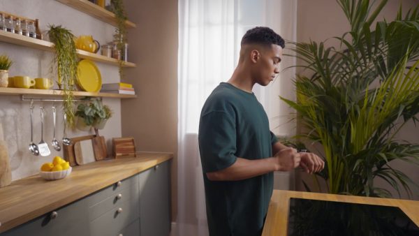 Man taking a Plenish shot in a kitchen